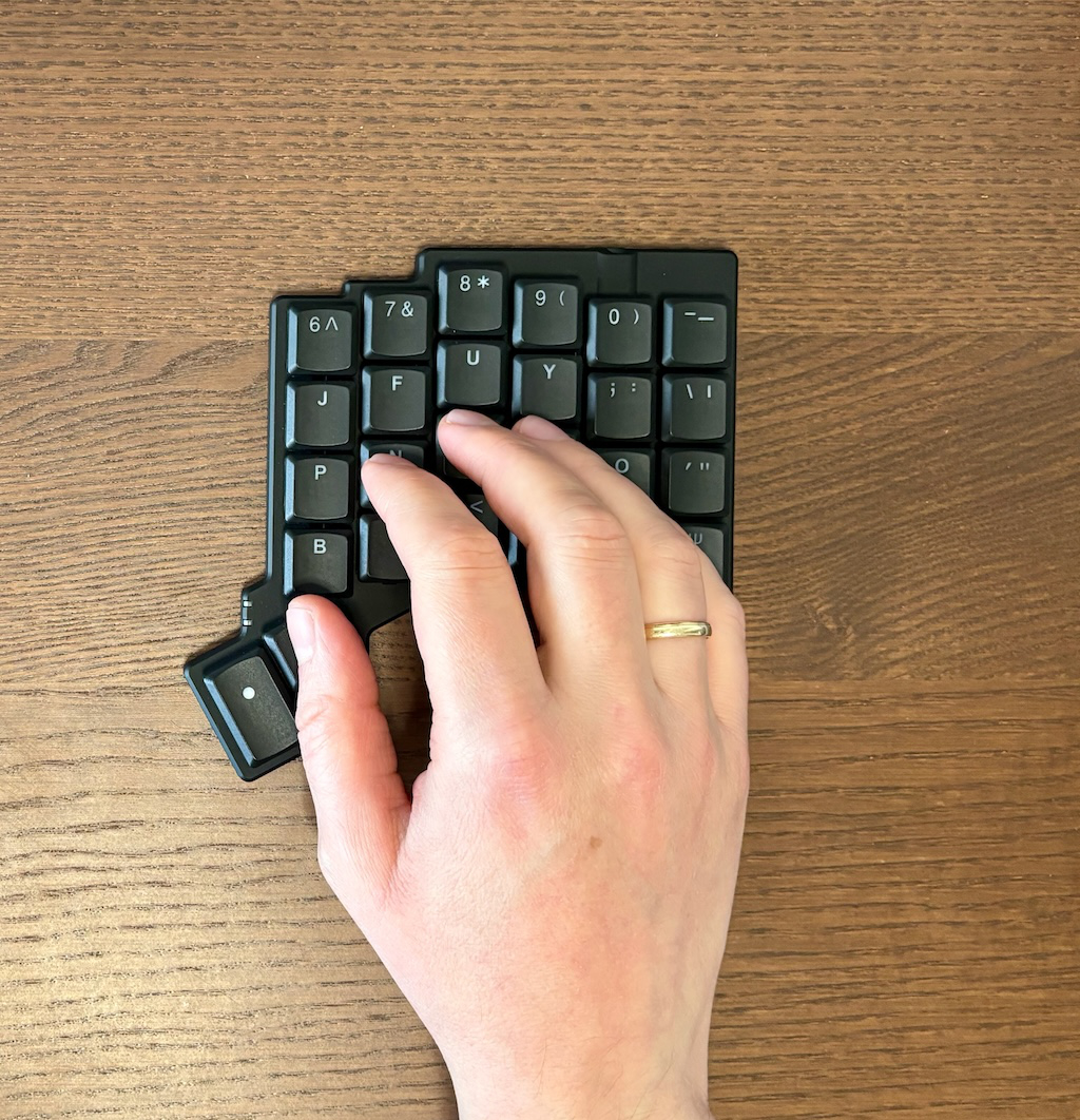 Hand on the keyboard with thumb on the inner thumb key