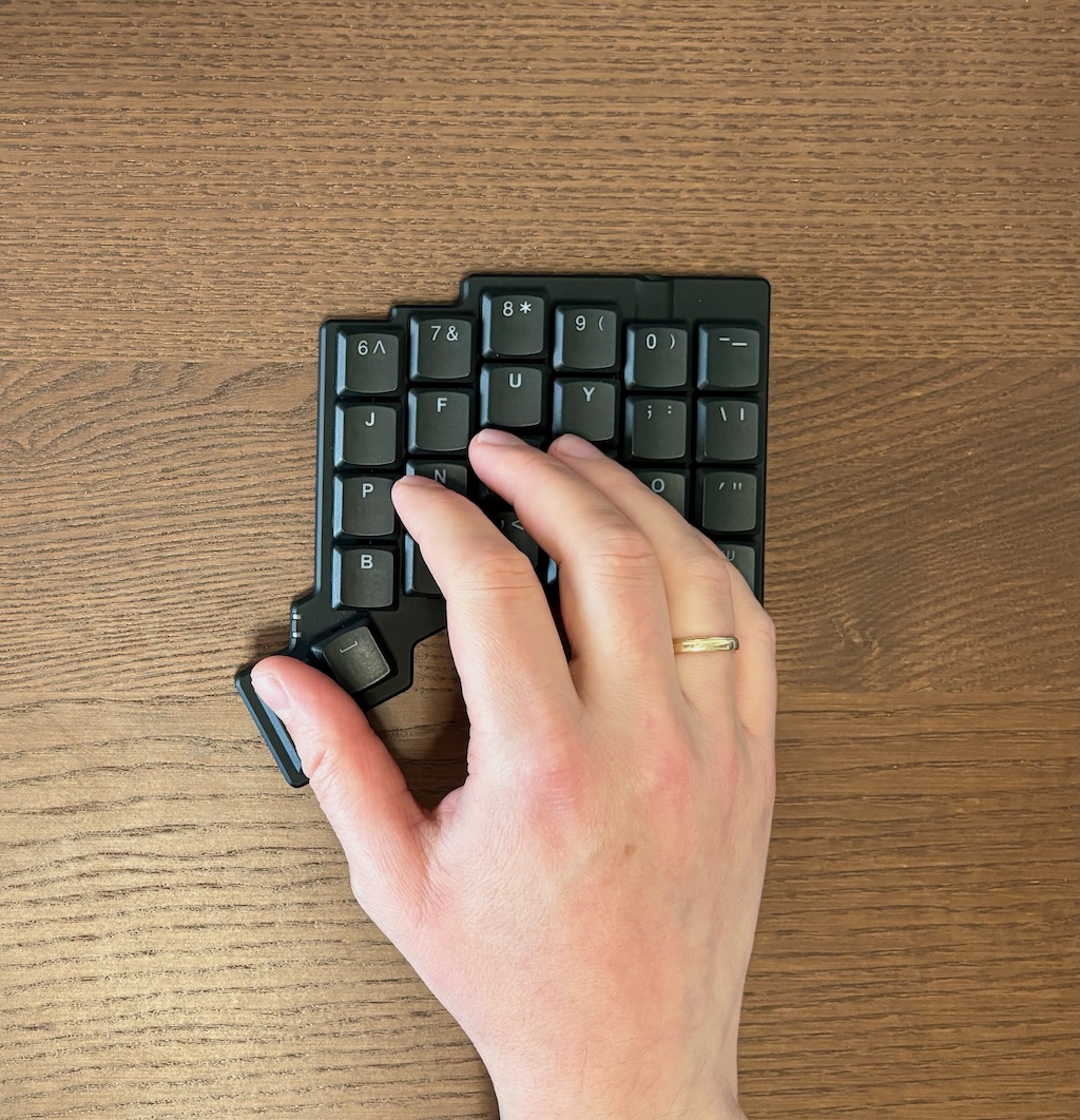 Hand on the keyboard with thumb on the outer thumb key